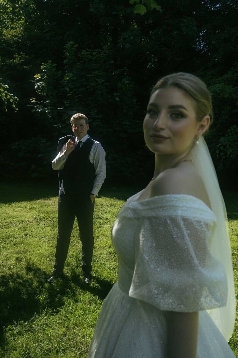 A romantic moment as a husband lovingly looks at his beautiful wife, showcasing their deep connection on their wedding day