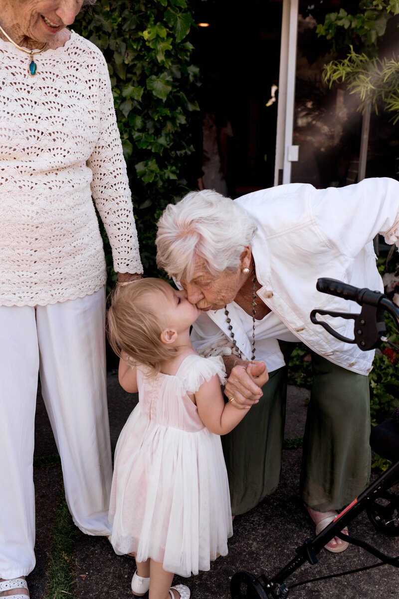 little girl kissing grandma