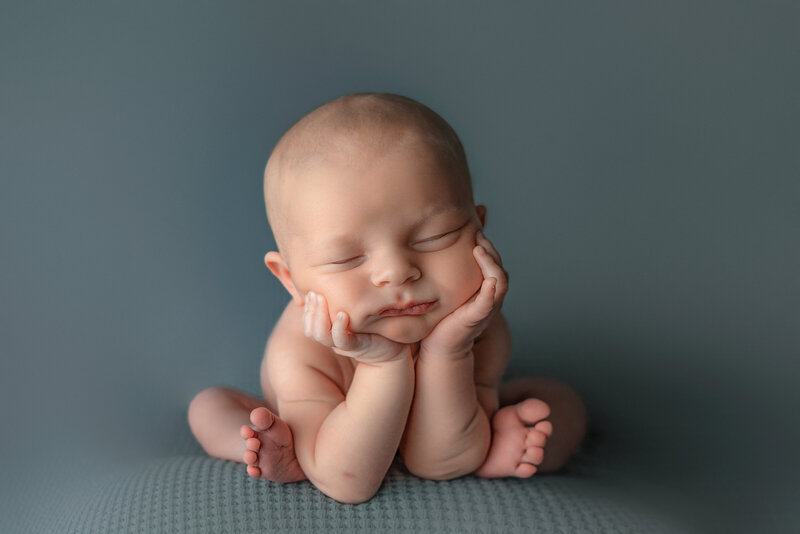 Baby in froggy pose for newborn photos