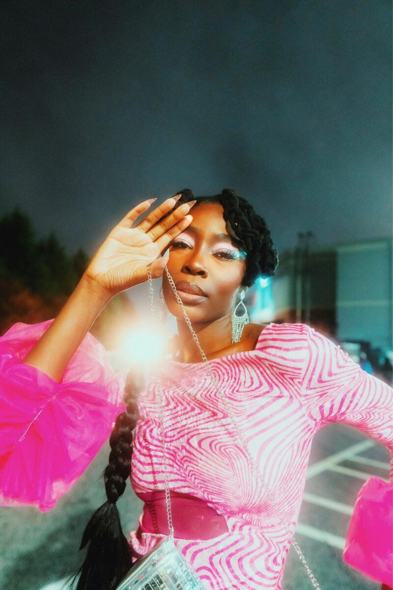 Light casting from a colorful wind over a smiling woman