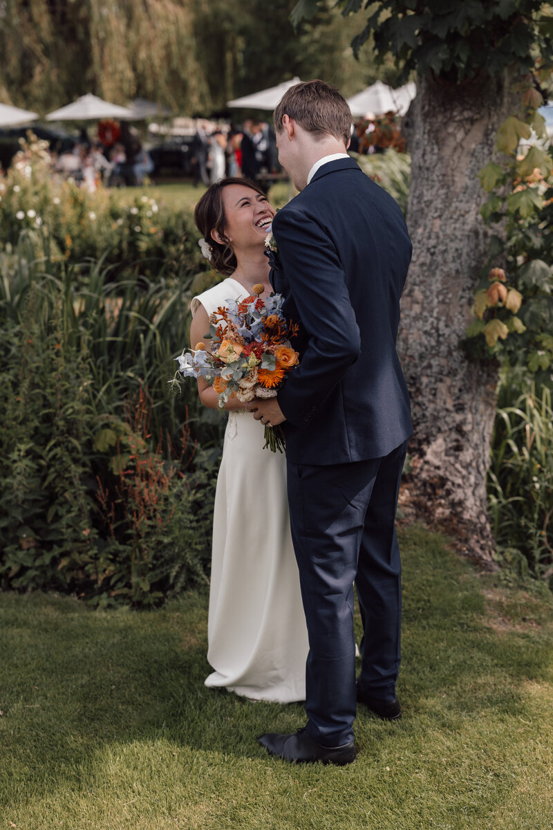 A wedding photographer captures the magical moment of a bride and groom celebrating their wedding ceremony as the bride throws the bouquet in the air