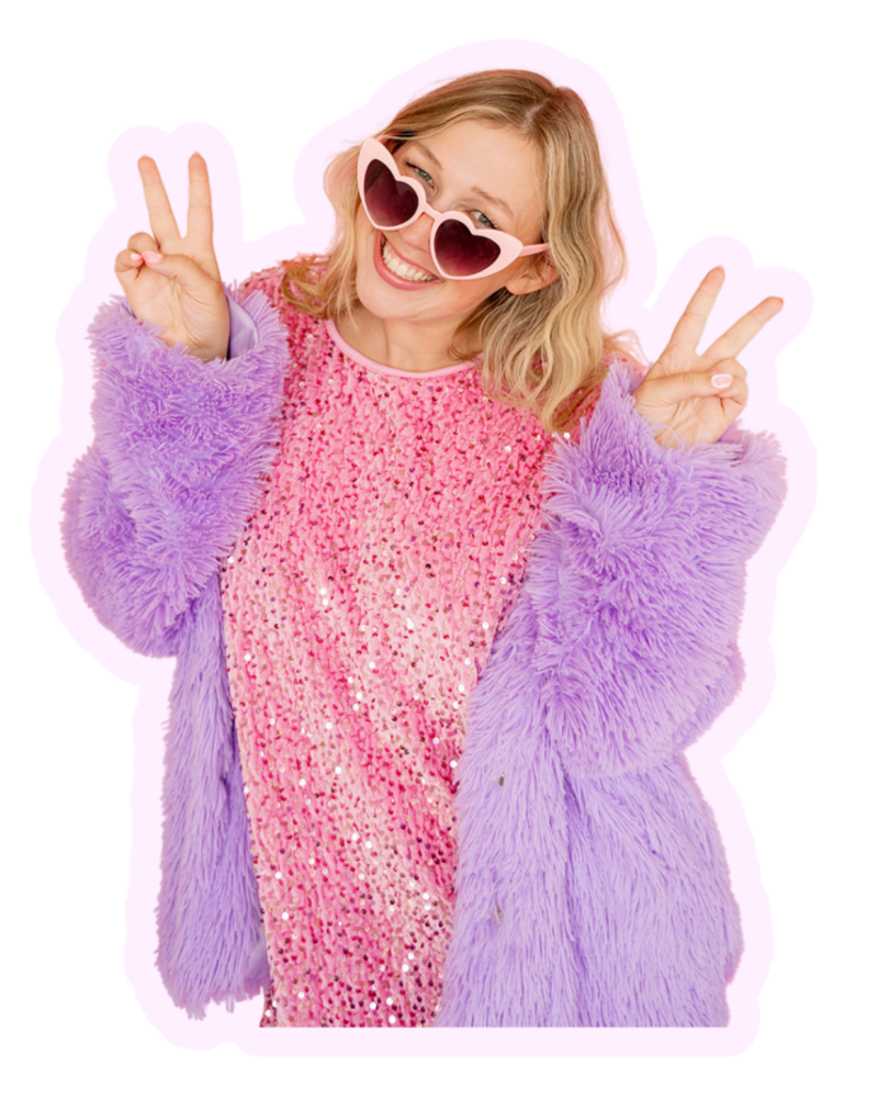 Cutout image of Kat Murphy in a light pink blazer holding an iphone in front of a pink background