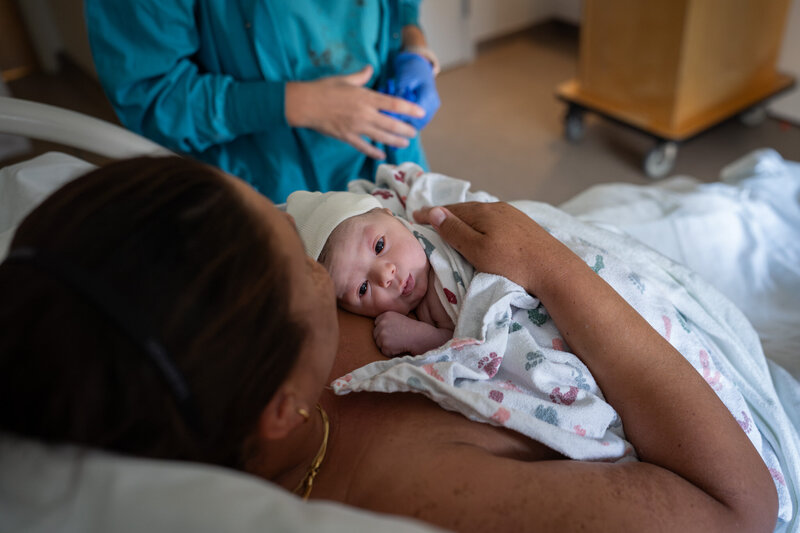 A mother is holding her baby for the first time after giving birth at EvergreenHealth Family Maternity Center in Kirkland, WA.
