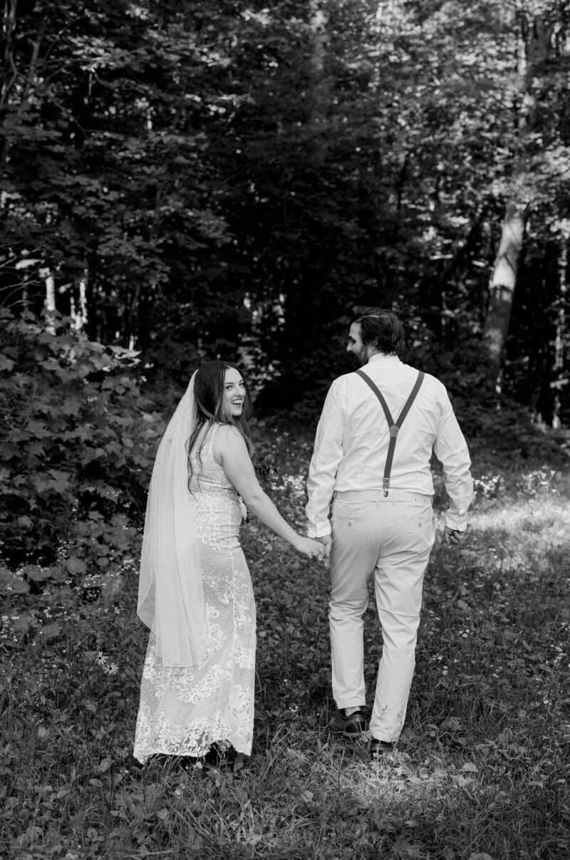 Candid forest wedding photo of bride and groom on their own 2‑acre property, Ottawa‑area wedding celebration