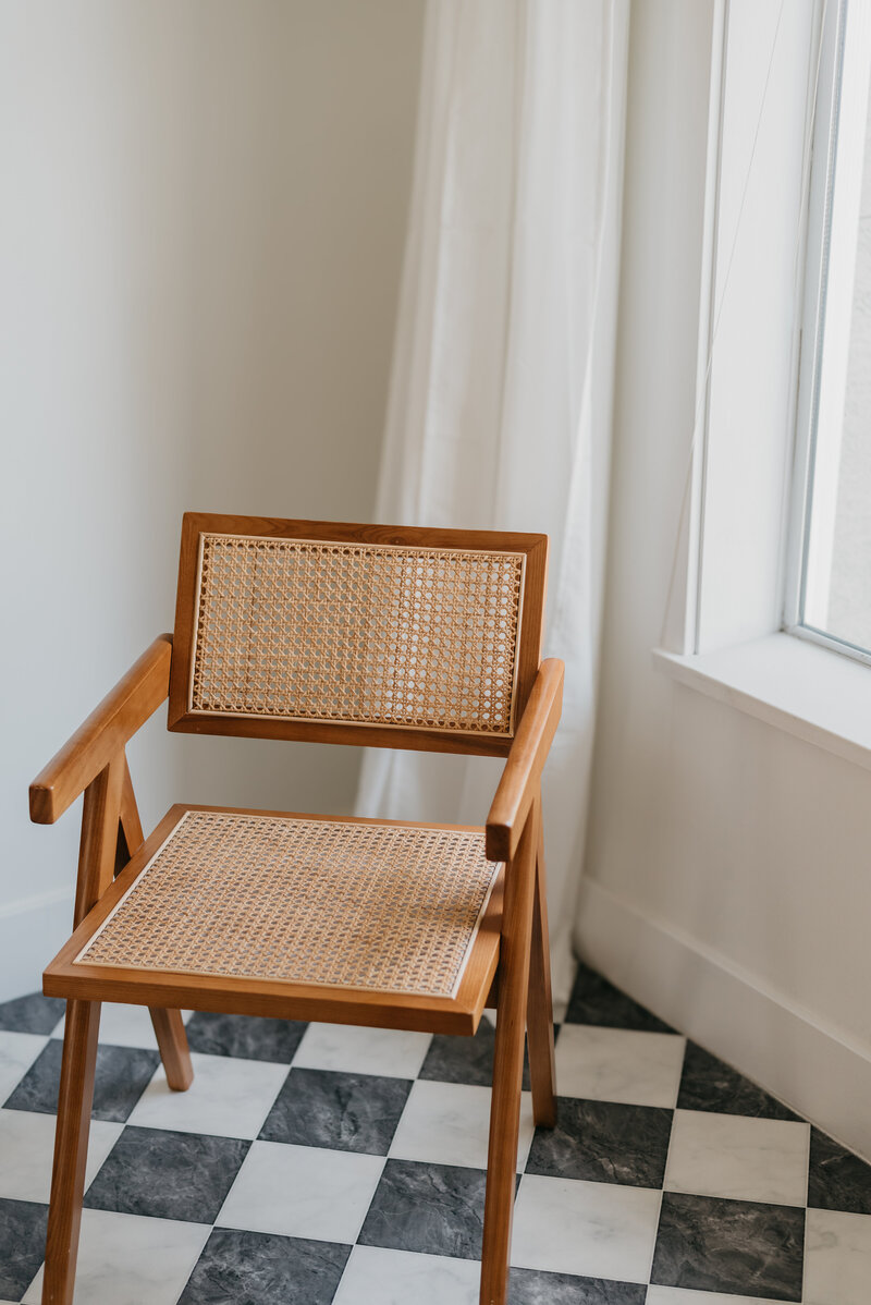 Chair on checkered tile in Twin Cities vintage home