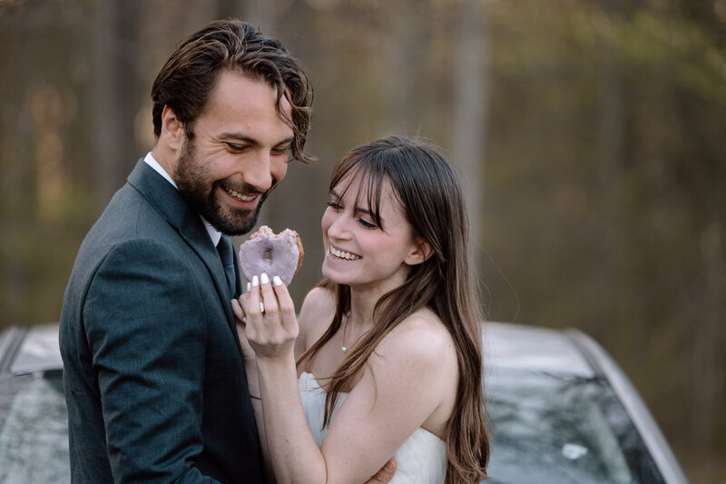 Bride and groom looking at a donut before their elopement in CVNP.