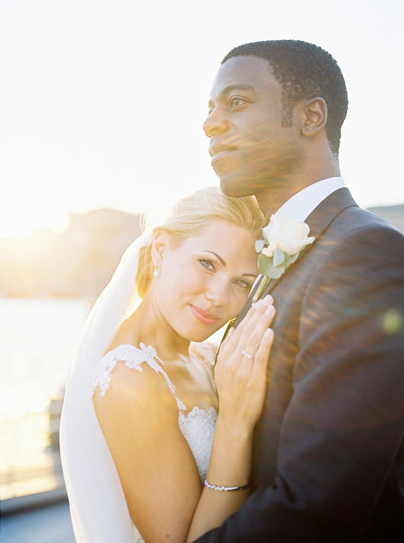 The bride and groom outside Grand Hotel Stockholm in the sunset