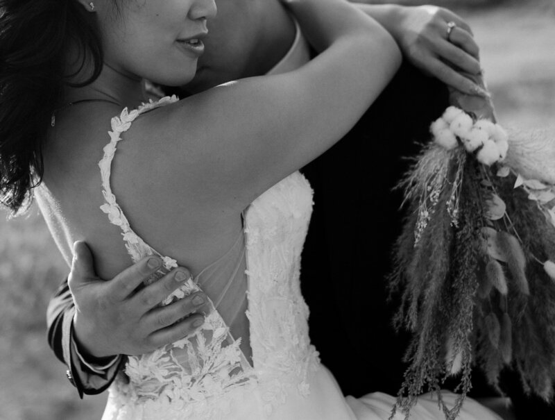 Bride and groom embrace during sunset at a luxury wedding in Saskatchewan, captured in a cinematic, documentary style.