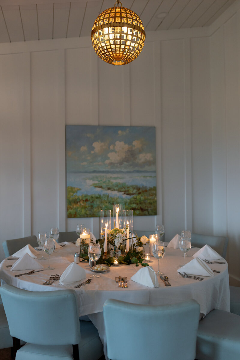 Elegant coastal wedding tablescape with gold flatware and blue linen napkins – The Dunes Club, Crystal Coast NC venue.