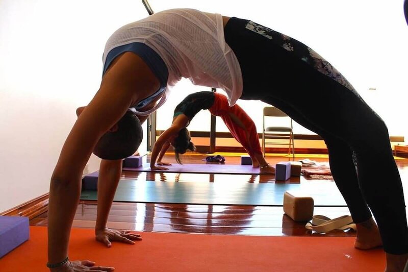 Students learning advanced backbend techniques and safety.