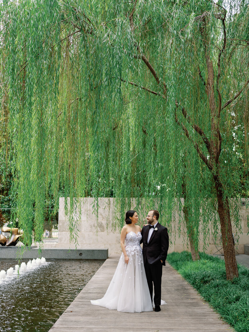 Bride and groom portraits at Rosewood Mansion on Turtle Creek, with the bride in a tulle ballgown and the groom in a tuxedo