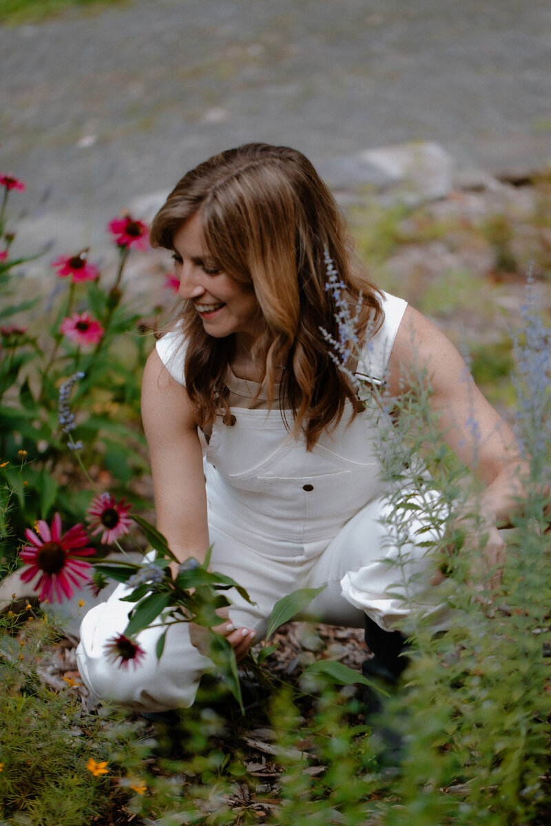 Sam wearing overalls working in her garden