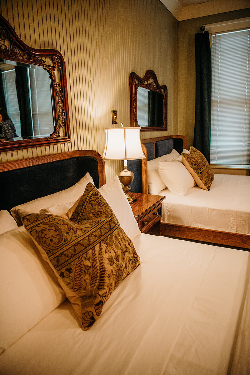 Luxe white bedding and cozy velvet headboards - are a hallmark of the new inn