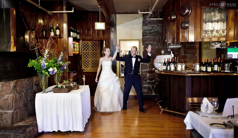Wedding couple enter their wedding reception in the Upstairs Dining Room at the Greenbriar Inn Restaurant in Boulder