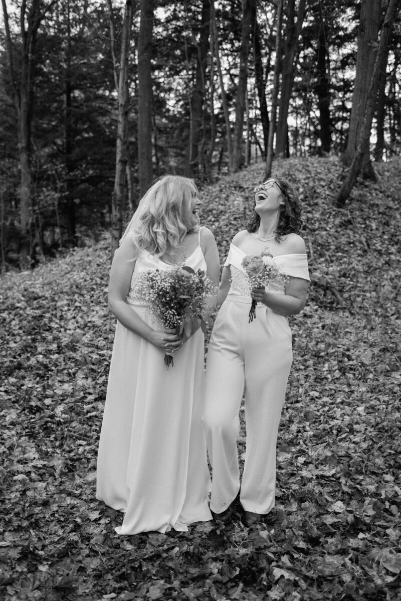 Hamilton brides laughing in the forest together