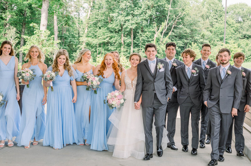 light and airy bridal party photo taken at a church in the woods