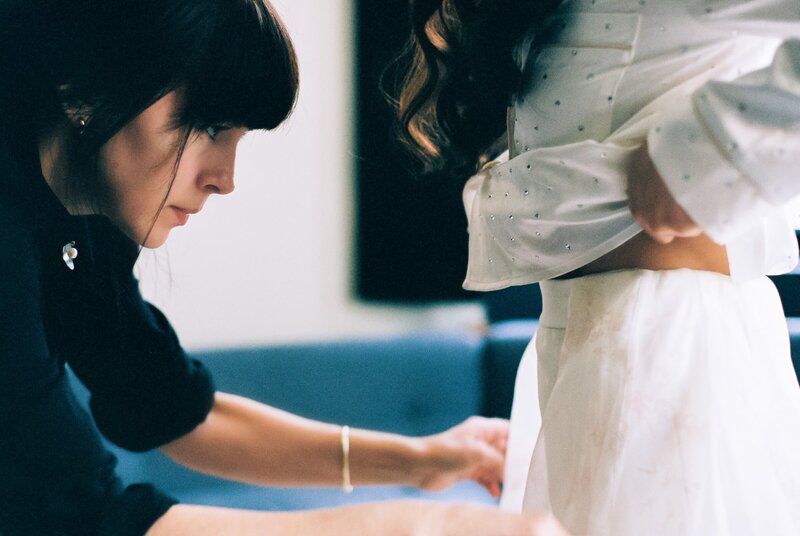 stylish NYC bride getting fitted no wedding day