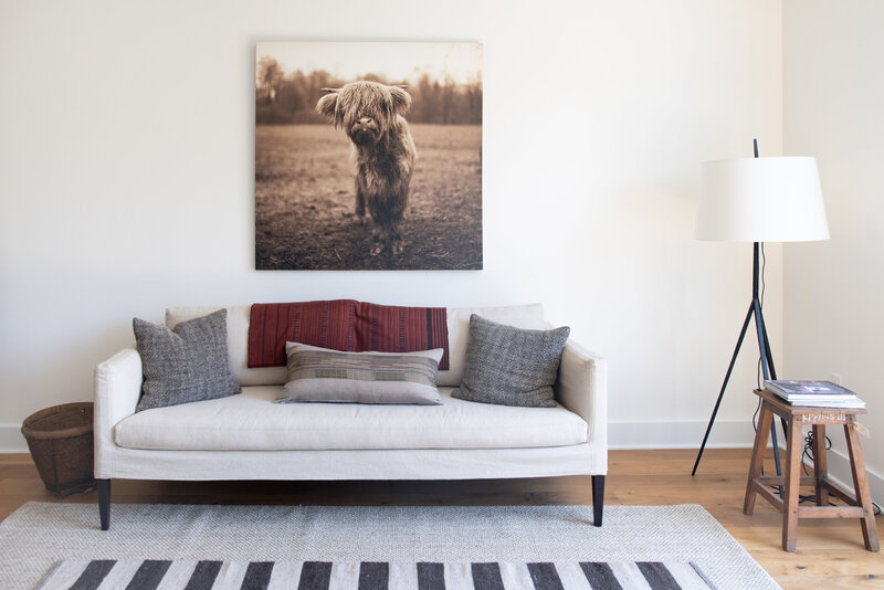 couch with canvas hanging on wall