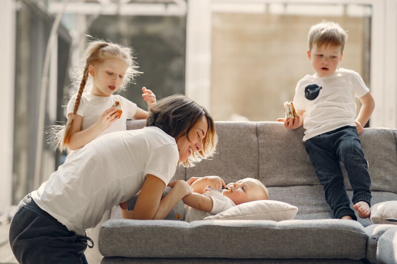 happy-mother-playing-with-children-at-home-4017415