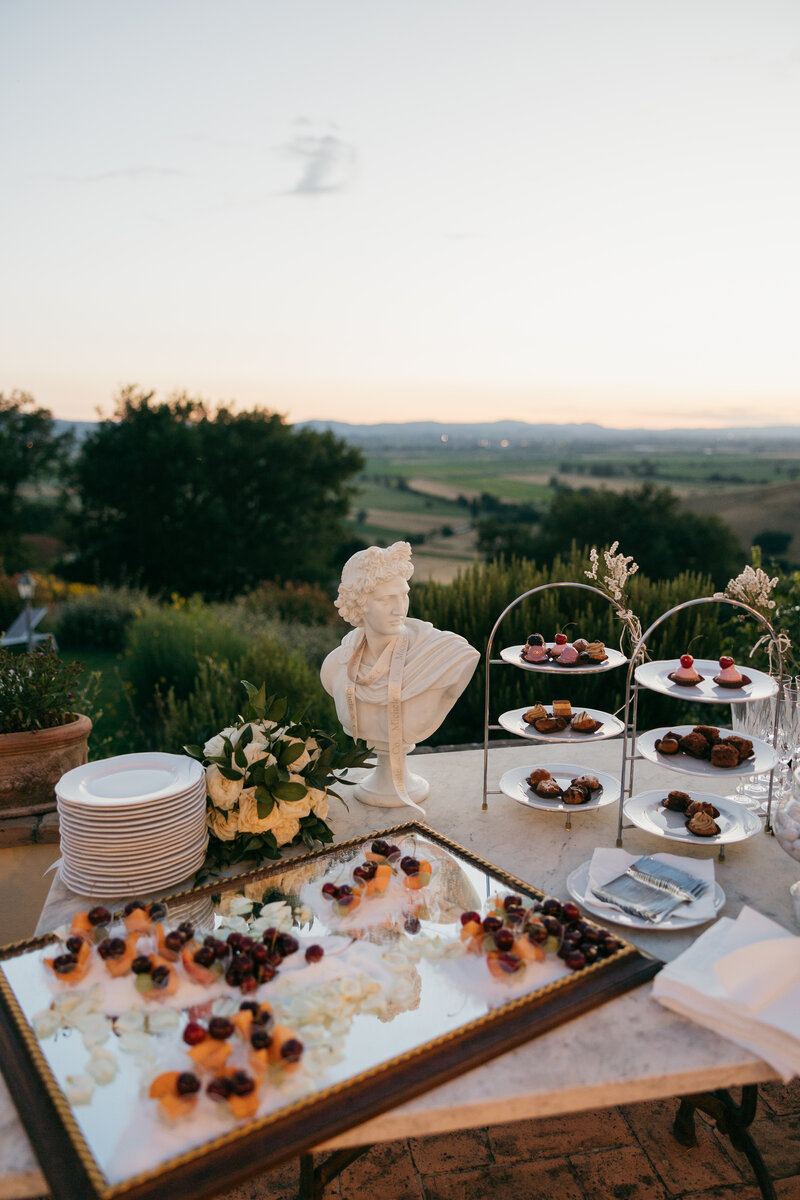 Tuscany, Italy Destination Wedding - catering reception dinner with roman statue