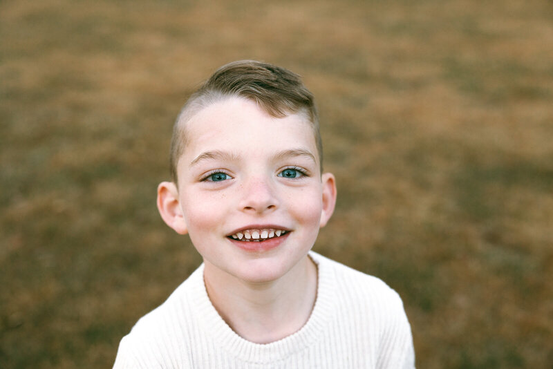 Close-up portrait taken of a child during family portrait session. 