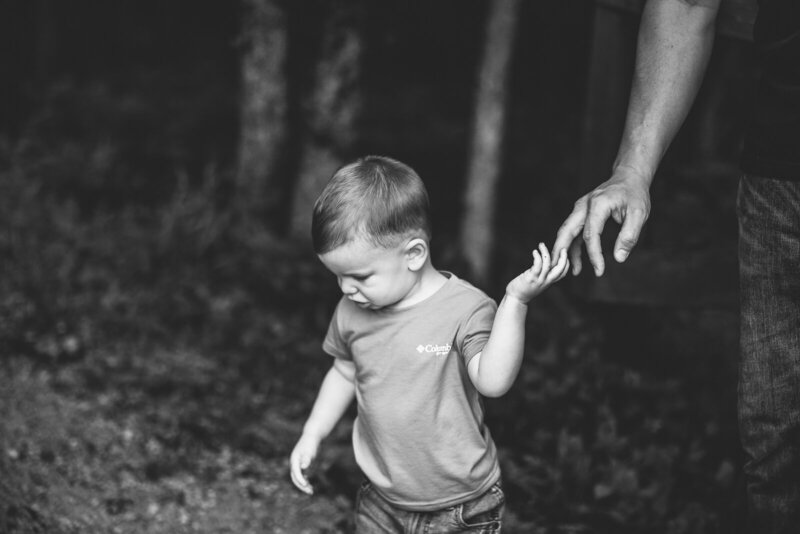 Portrait of toddler boy holding dads hand in Farmington, Missouri