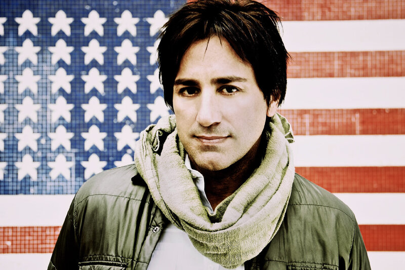 Branding Headshot featuring Steve Azar The Delta Man standing in front of American flag wearing scarf and jacket
