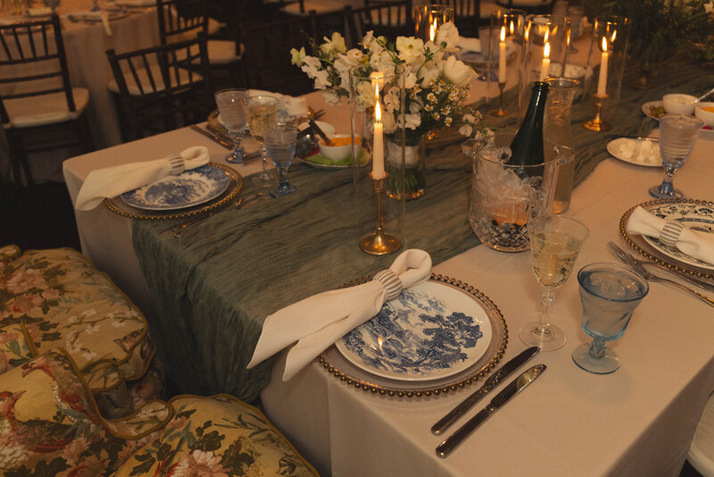 Elegantly set dinner table with candles and floral centerpieces, creating a warm and intimate atmosphere for a wedding reception