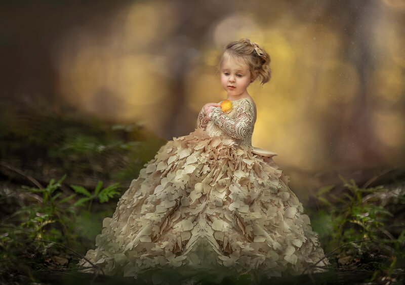 A young girl captured during the golden hour in a breathtaking golden gown, with soft, warm light creating a magical portrait session in Ottawa."