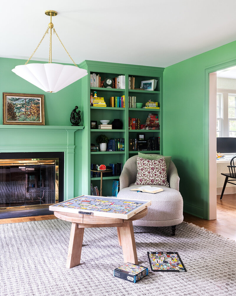 bright green living room with shelves and chair