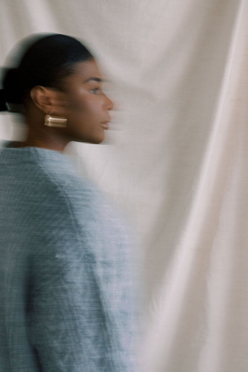 blurry photo of a woman walking in a sweater