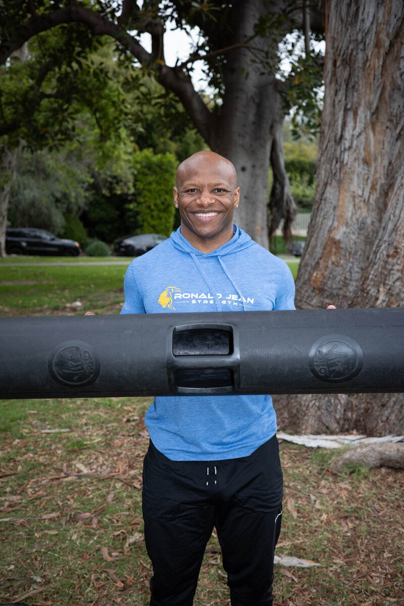 smiling man holding fitness equipment