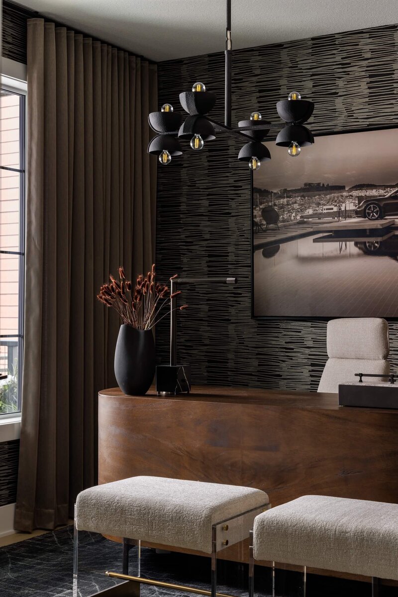 Home office with walnut detailed desk and black and copper tones.