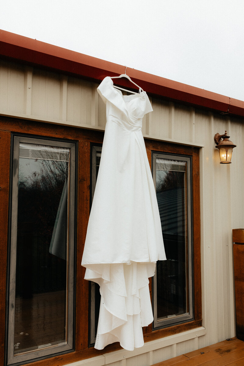 Wedding dress hanging outside.