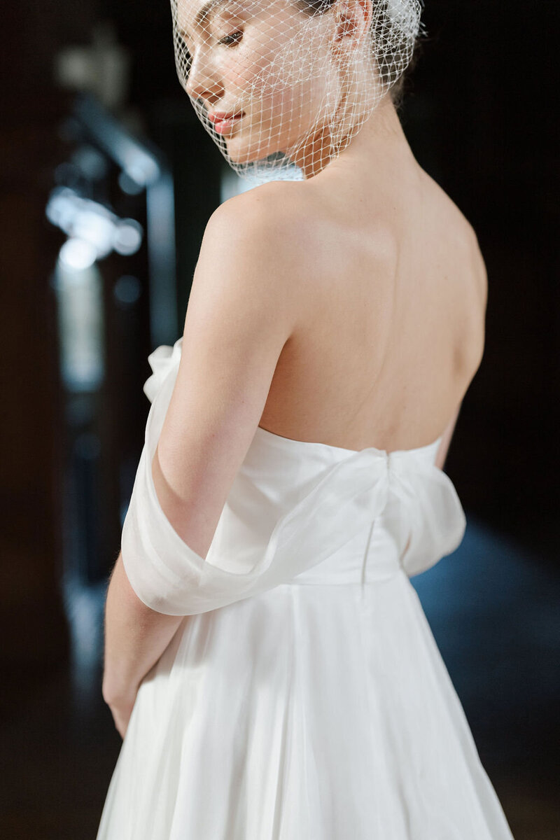 bride showing back of wedding dress