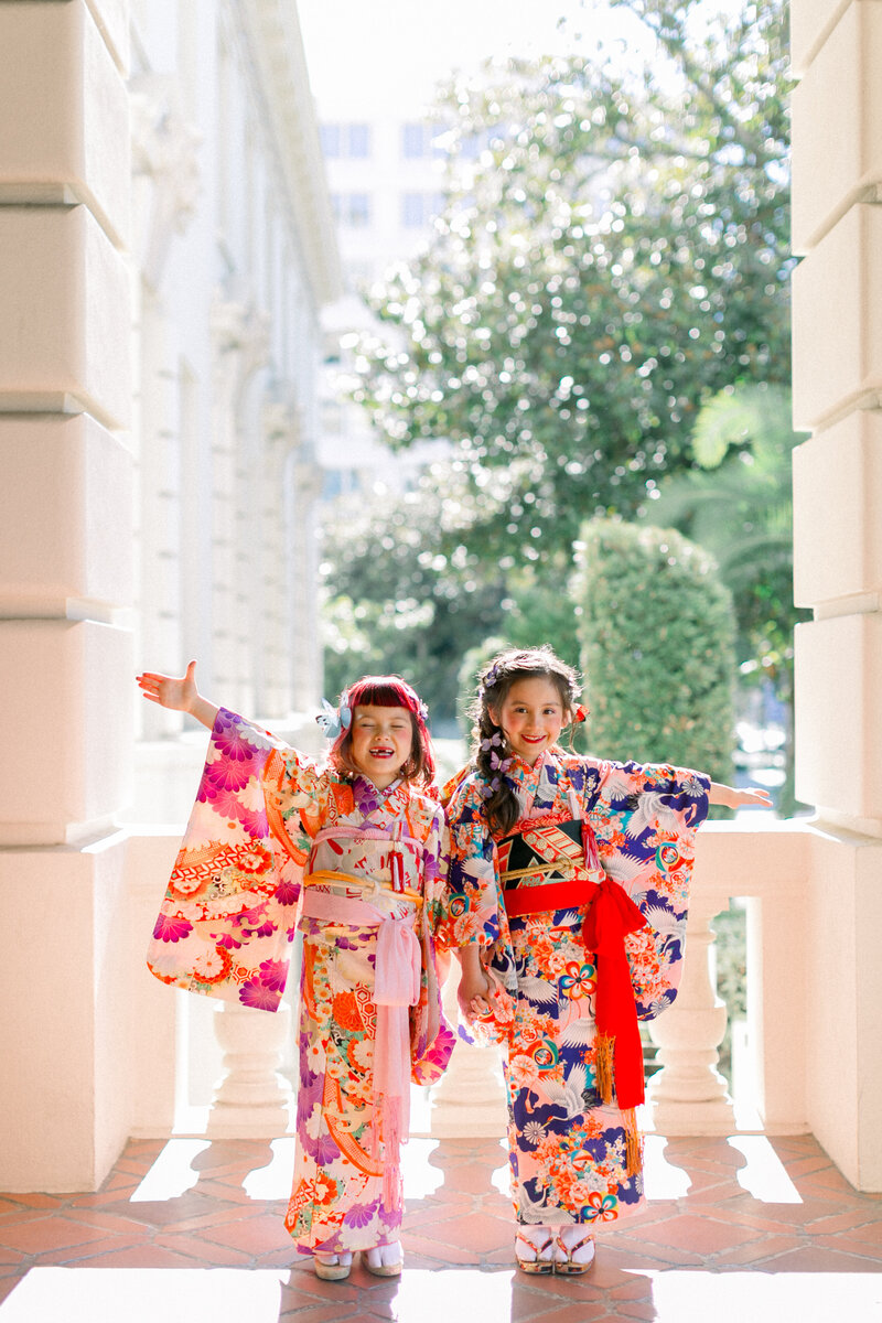 Two young girls dressed in colorful kimono for Shichi-Go-San (七五三) celebration, traditional Japanese children’s ceremony.