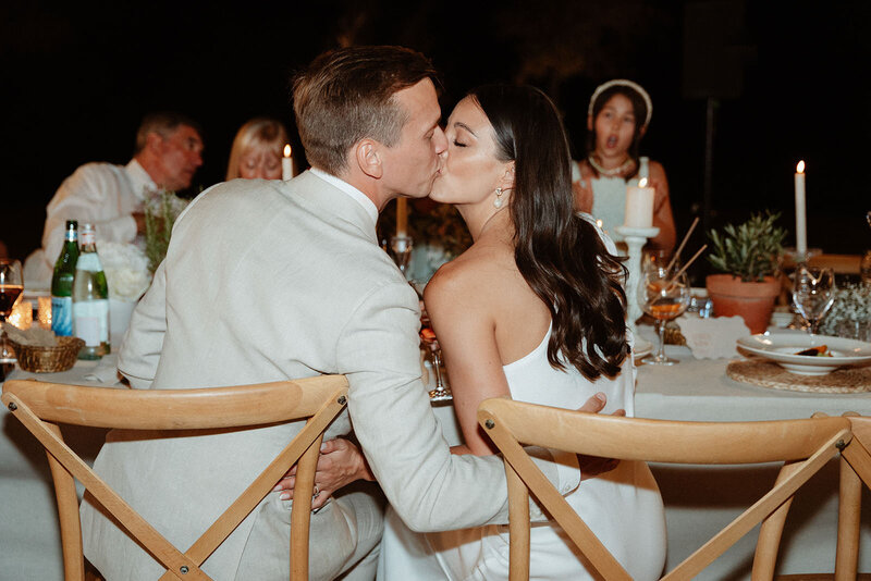 a couple kissing during their wedding dinner in Provence