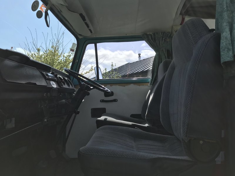 Inside view of drivers and passenger seating of Rhonda, teal retro kombi van from NZ Kombi Hire