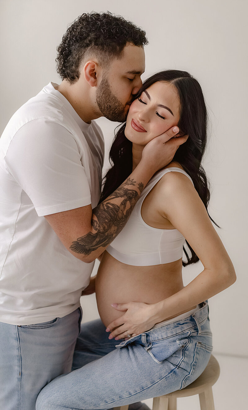 denver maternity photographer poses stunning couple for their pregnancy photos in her studio