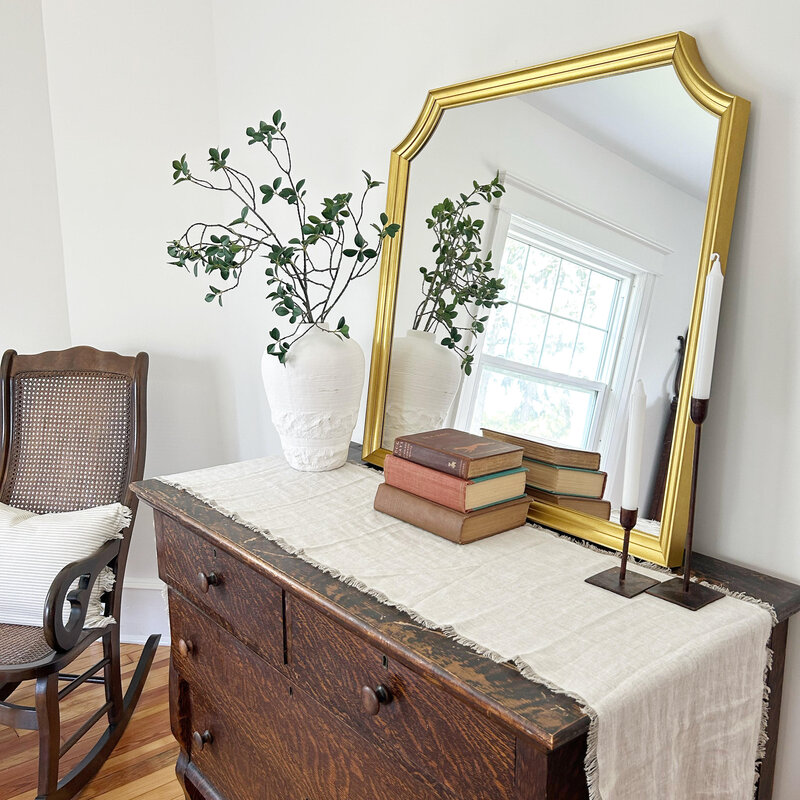 Decorative antique dresser with gold mirror