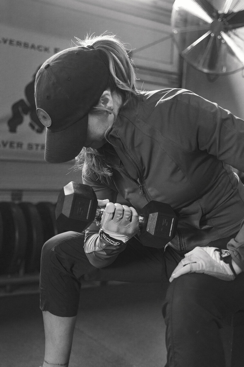 Woman is doing bicep curls at a personal training session with Sarnia's best personal trainer Jim Stewart with Silverback Fitness.