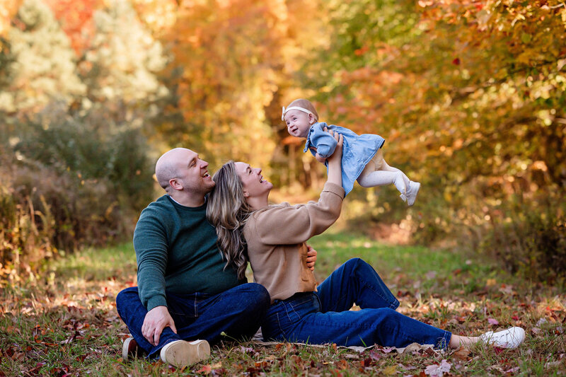 family smiling with baby at photo session leeann marie photography studio