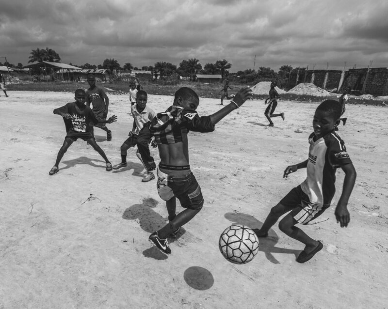 Liberian Kids Playing Soccer and Smiling
