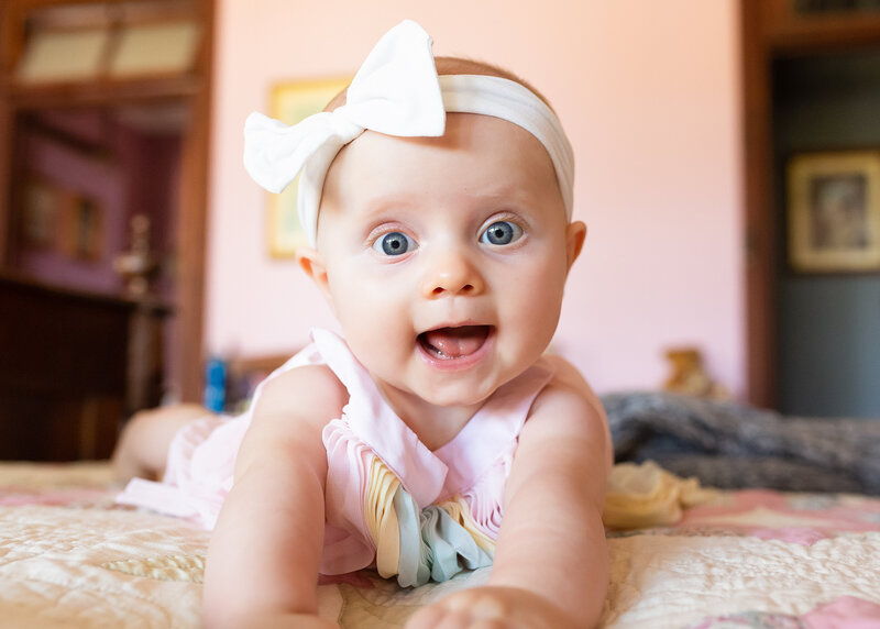 Baby with head bow smiling