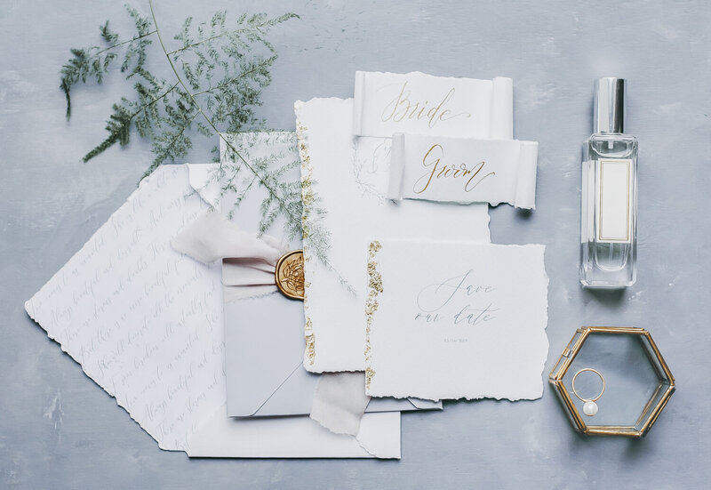 A flat arrangement of romantic wedding invitations.