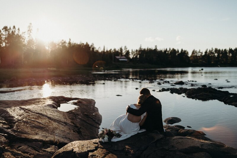 A couple embracing in front of a moody Scottish Highlands