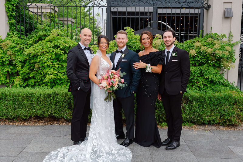 a bride and groom photographed with their immediate family.  Captured outdoors by Ottawa wedding photographer JEMMAN Photography