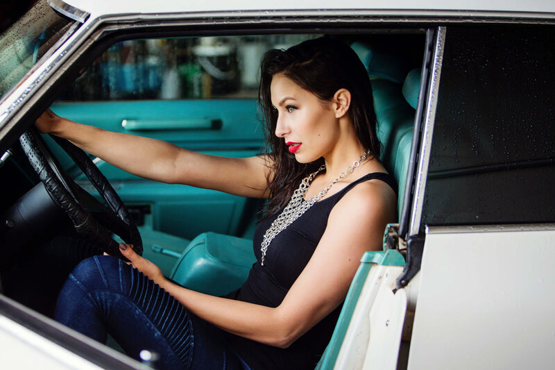 model  with red lipstick in vintage cadillac