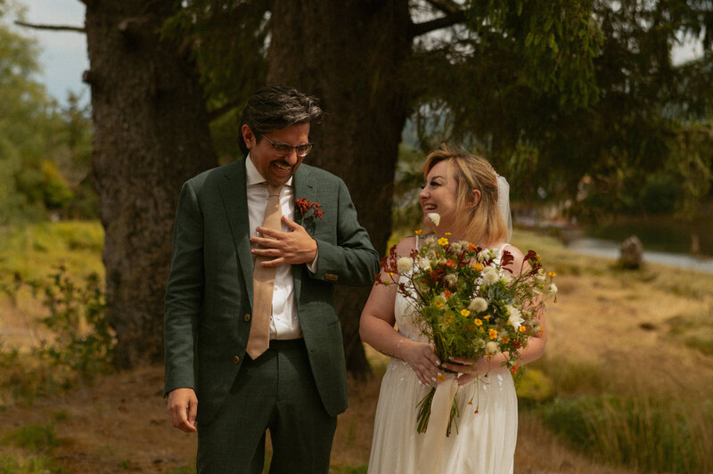 Couple enjoying their elopement laughing at each other after the first look.