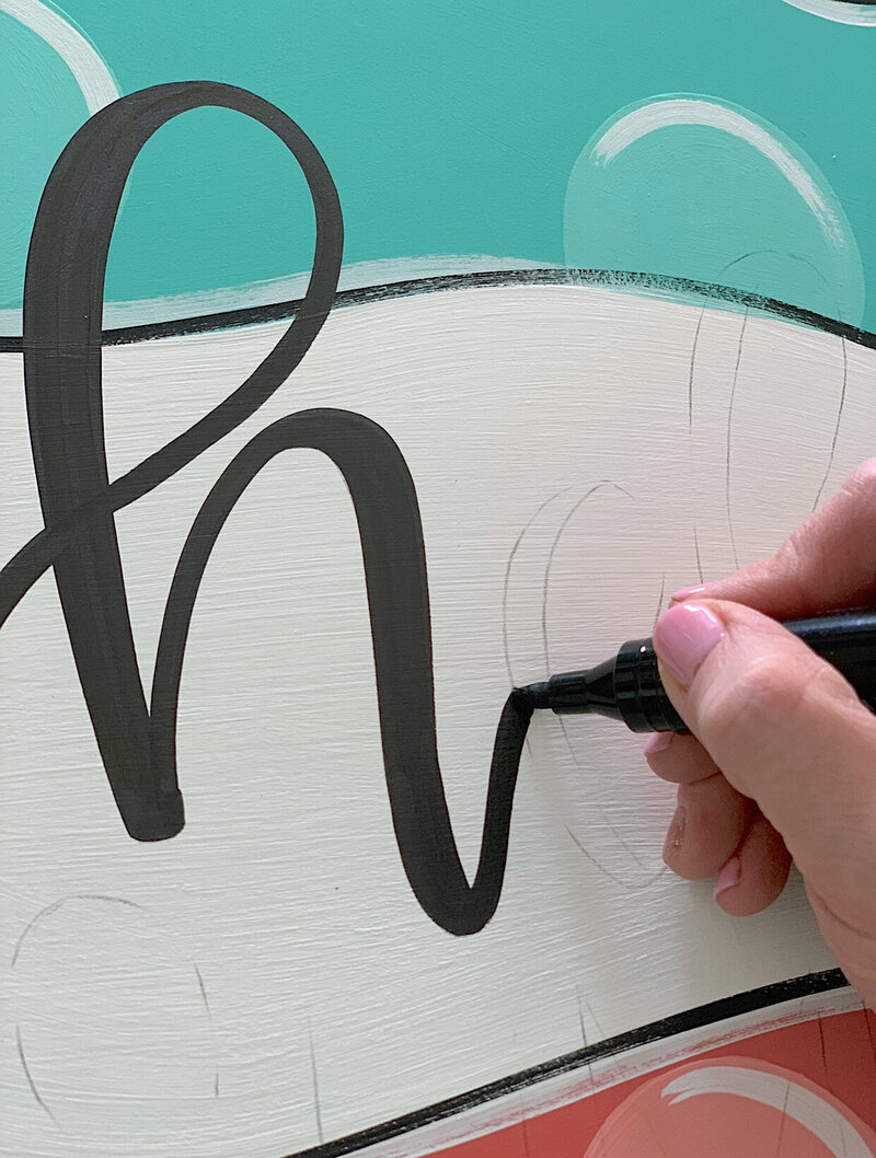 Hand lettered h on white and teal background